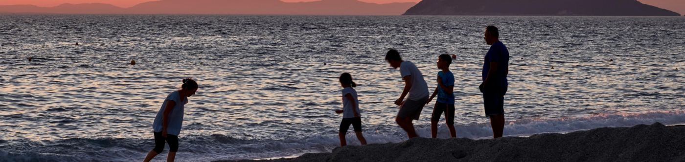 Image of family playing on the beach