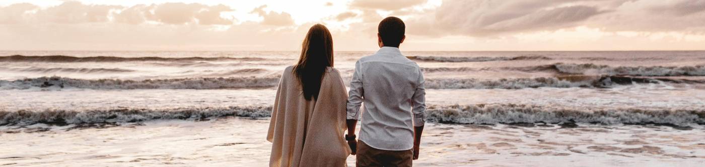 Picture of a couple sharing a romantic moment standing on the beach